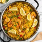 Delicious seafood rice recipe with shrimp, mussels, and squid in a vibrant dish.