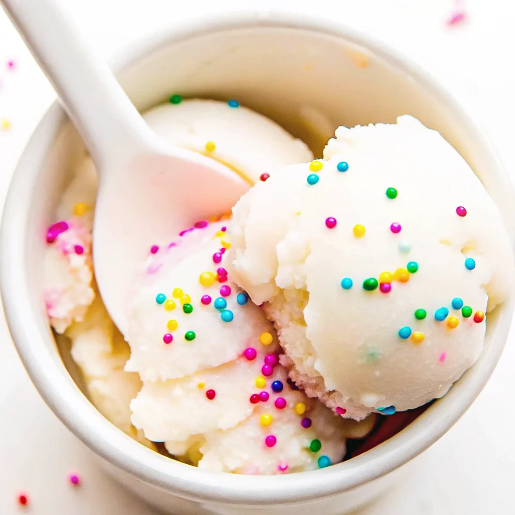 Homemade Snow Cream topped with sprinkles in a bowl, made from fresh snow and vanilla.
