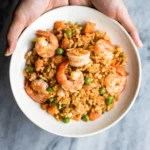eafood rice ingredients including shrimp, mussels, vegetables, and spices for a flavorful dish.