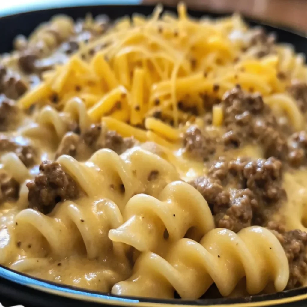 Cheesy Ground Beef Stroganoff Pasta Casserole with melted cheese and creamy sauce.