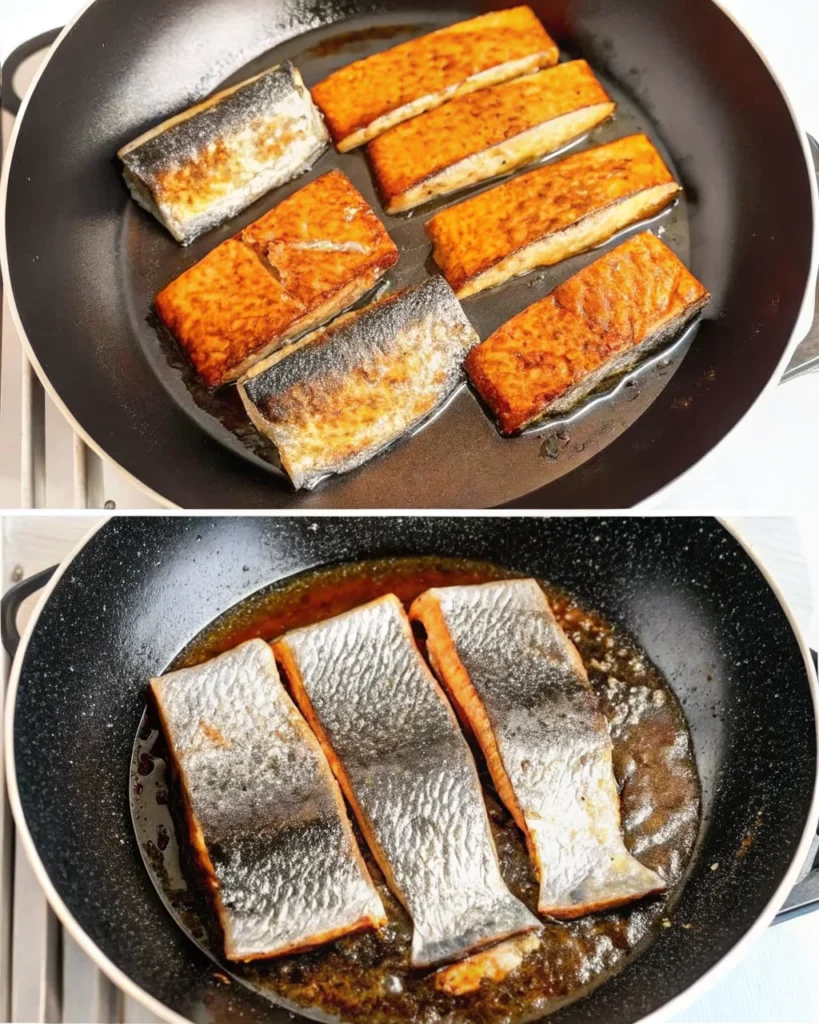 Cajun honey butter salmon fillets sizzling in a skillet, featuring a golden, caramelized crust and garnished with fresh herbs—perfect for healthy salmon recipes.