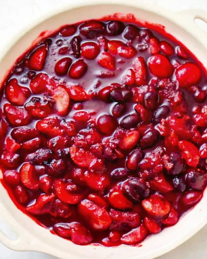 Close-up of a freshly baked cherry crisp recipe with juicy cherries and a golden crumble topping.