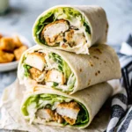 Chicken Caesar Wrap bursting with grilled chicken, crisp romaine lettuce, crunchy croutons, and creamy Caesar dressing, wrapped in a soft tortilla—perfect for fresh spring meals.