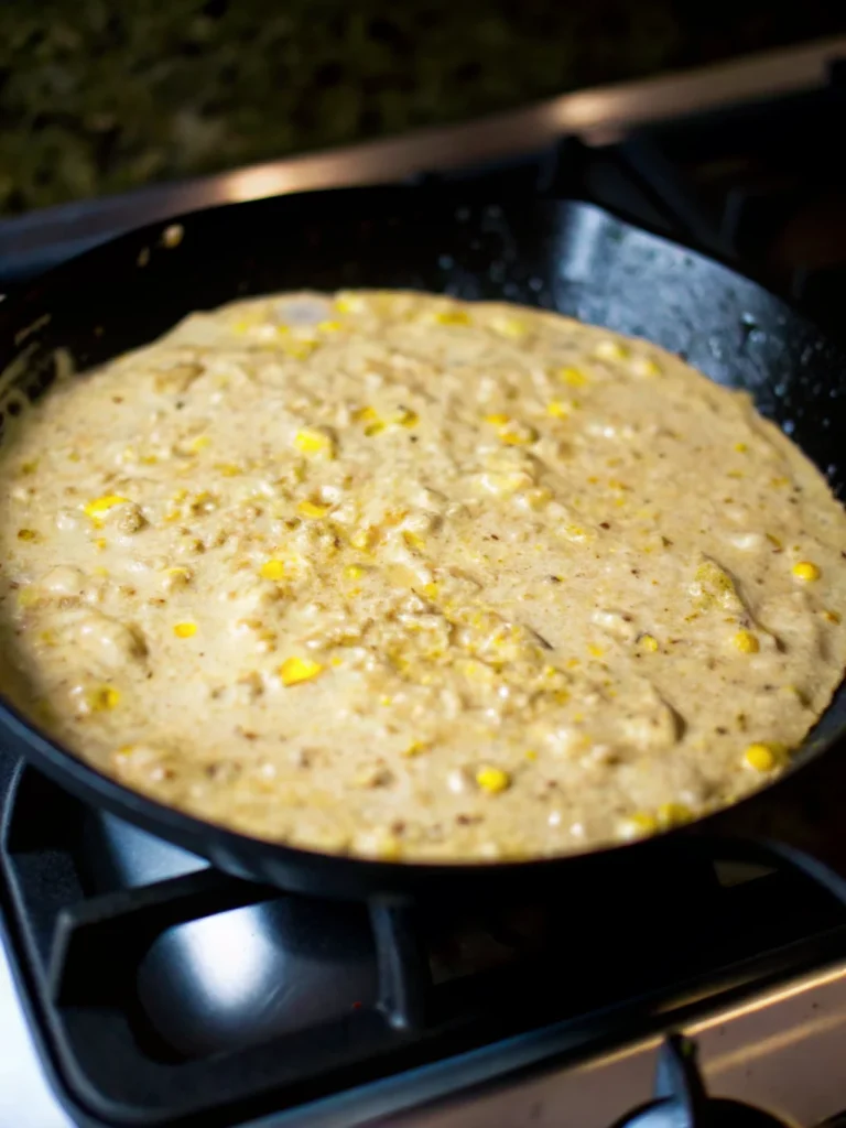 Mexican Street Corn and Shrimp with fresh cilantro, lime, and feta in a skillet, served as a summer Mexican recipe.