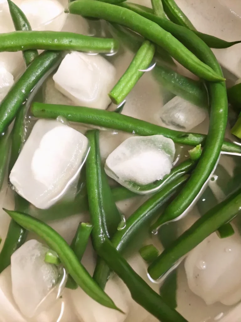 Homemade dilly beans pickled green beans in mason jar with dill and spices ready to eat
