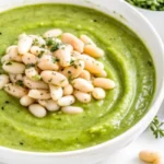 Creamy zucchini soup recipe with white beans garnish in bowl, healthy vegetable soup with herbs