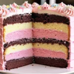 Neapolitan cake with three distinct layers - chocolate, vanilla, and pink strawberry - topped with pink buttercream frosting and colorful sprinkles