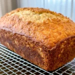 Freshly baked pumpkin bread slices on parchment paper showing moist golden texture and perfect spiced quick bread consistency