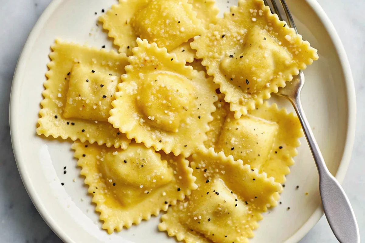 Hands kneading golden fresh ravioli pasta dough on wooden cutting board with flour and eggs nearby for homemade ravioli recipe