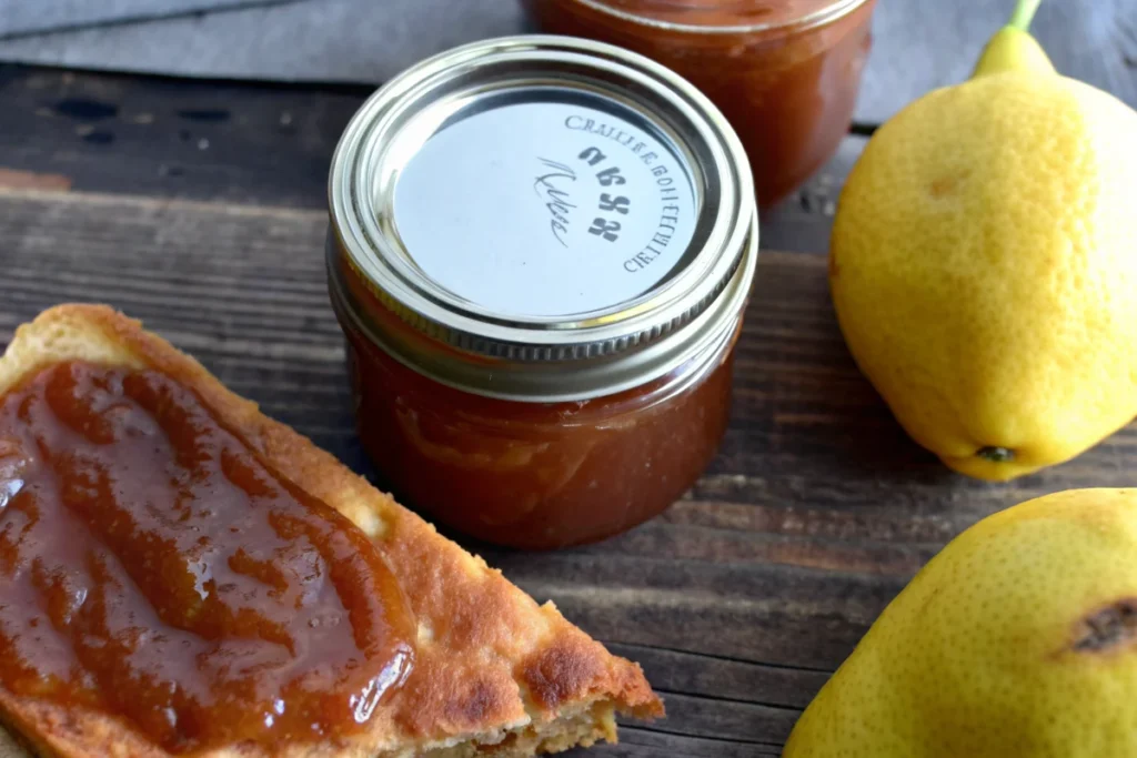 Easy Crockpot pear butter recipe in a jar with spoon, slow cooker pear butter made from Bartlett and Anjou pears with pumpkin pie spice