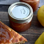 Easy Crockpot pear butter recipe in a jar with spoon, slow cooker pear butter made from Bartlett and Anjou pears with pumpkin pie spice