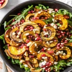 Golden roasted delicata squash rings with caramelized edges on parchment-lined baking sheet, delicata squash recipe