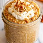Creamy pumpkin pie overnight oats in mason jar topped with pecans and cinnamon for healthy fall breakfast meal prep