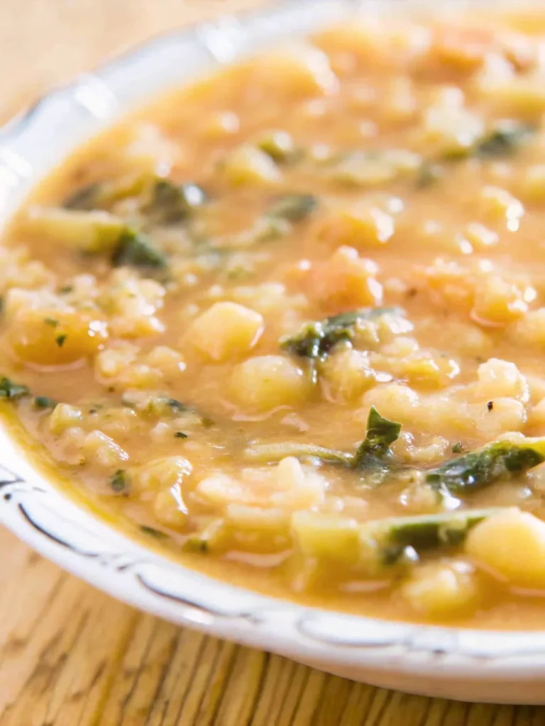 Best white bean soup recipe in rustic bowl with fresh herbs and olive oil drizzle, featuring cannellini beans, vegetables, and aromatic seasonings for healthy comfort food