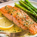 Perfect pan-seared salmon recipe with golden crust and creamy garlic lemon butter sauce on white plate