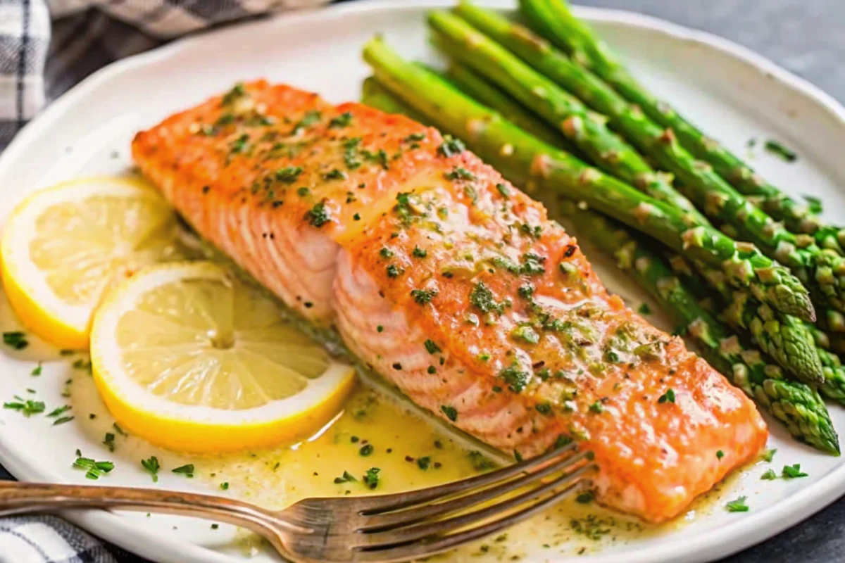 Perfect pan-seared salmon recipe with golden crust and creamy garlic lemon butter sauce on white plate