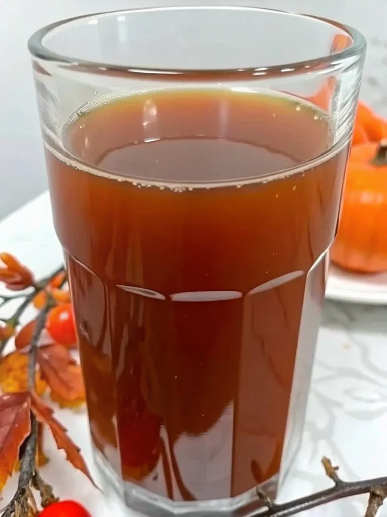 Easy homemade apple cider recipe with fresh apples, cinnamon sticks, and warming spices simmering in a large pot