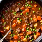 Hearty homemade beef stew with tender chuck meat, carrots, potatoes, and rich brown gravy in rustic bowl with crusty bread