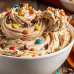 Sweet Swirled Peanut Butter Dip in serving bowl with chocolate swirl pattern, surrounded by graham crackers and fruit dippers, showing creamy texture with colorful mix-ins
