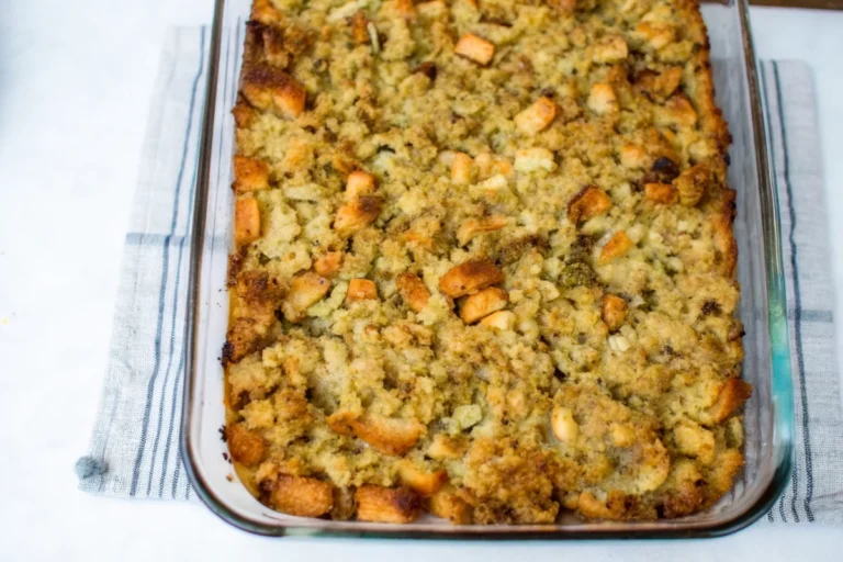 Golden brown Grandma's Thanksgiving dressing in a 9x13 baking dish with crispy edges and herbs, perfect southern style holiday side dish