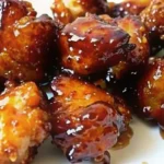 Sweet Hawaiian Crockpot Chicken Recipe with tender chicken pieces in glossy pineapple brown sugar sauce, served over white rice with tropical garnishes