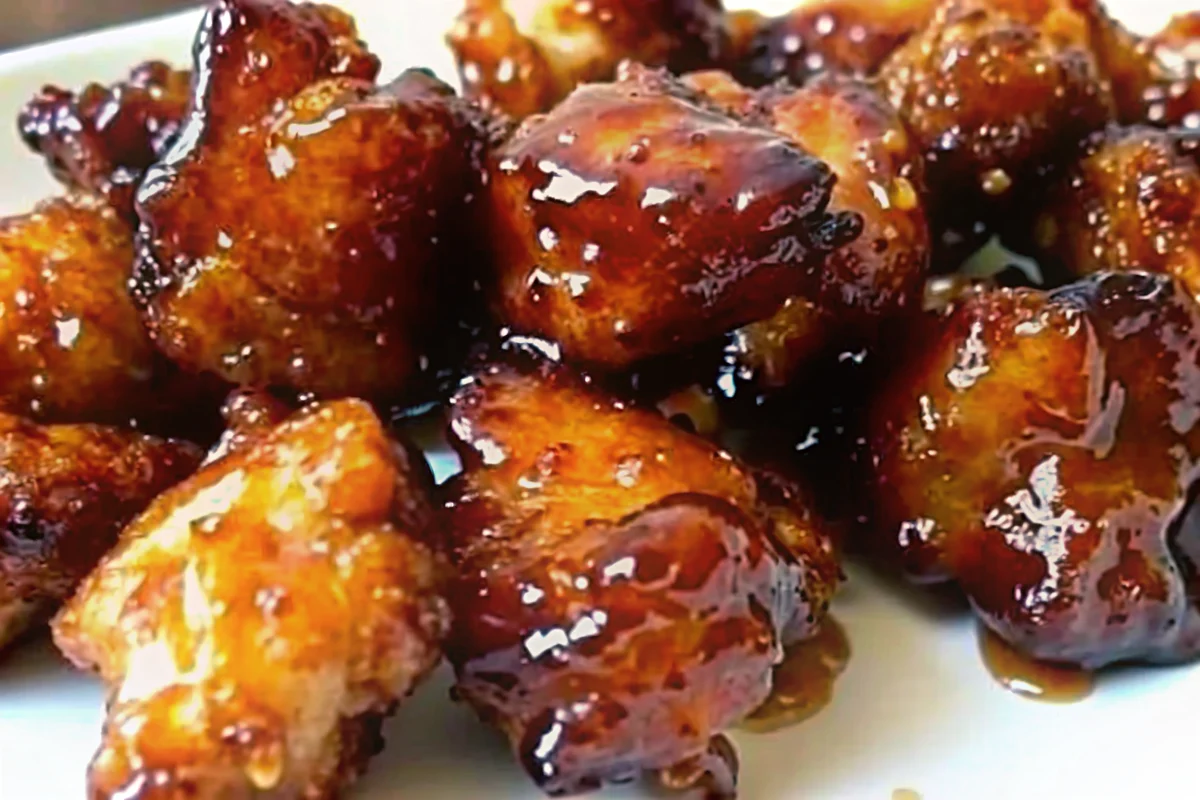 Sweet Hawaiian Crockpot Chicken Recipe with tender chicken pieces in glossy pineapple brown sugar sauce, served over white rice with tropical garnishes