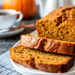 Ultimate moist pumpkin bread recipe with perfect golden crumb, sliced and ready to serve, featuring warm autumn spices and tender texture