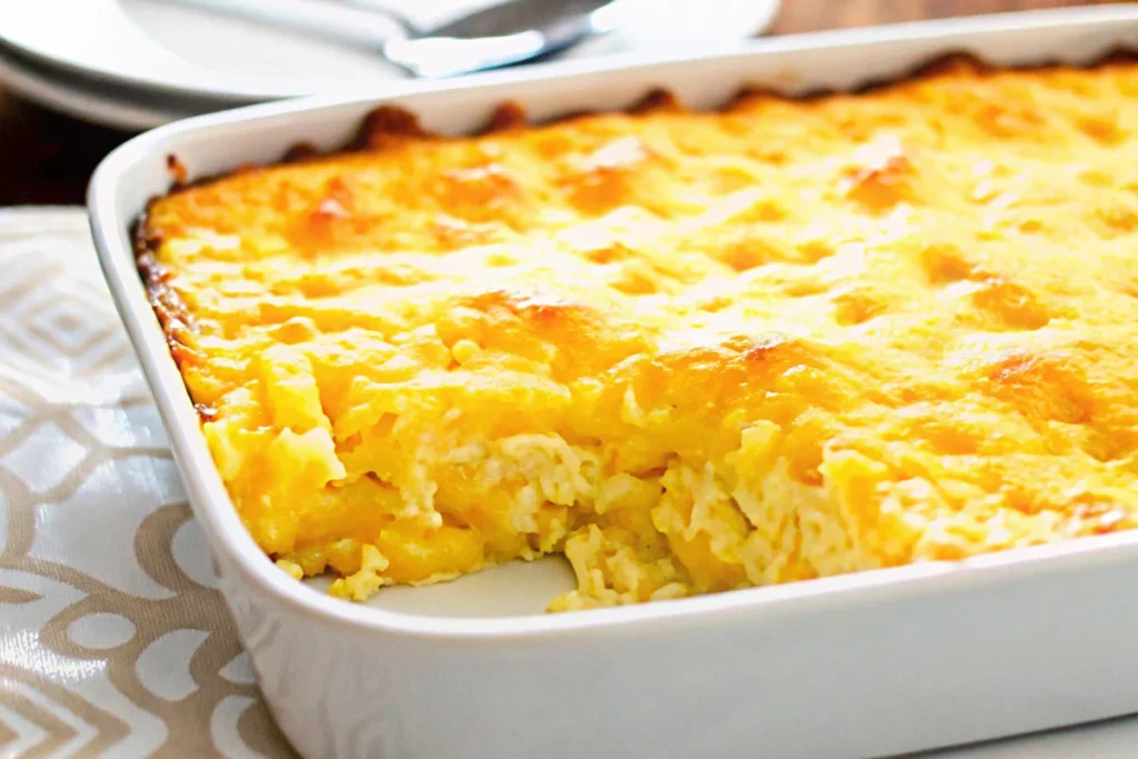 Golden corn casserole in baking dish with creamy texture and perfectly baked top