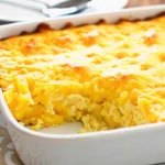 Golden corn casserole in baking dish with creamy texture and perfectly baked top